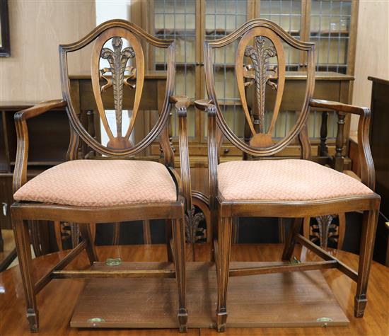 A set of eight Hepplewhite style mahogany shield back dining chairs, two with arms